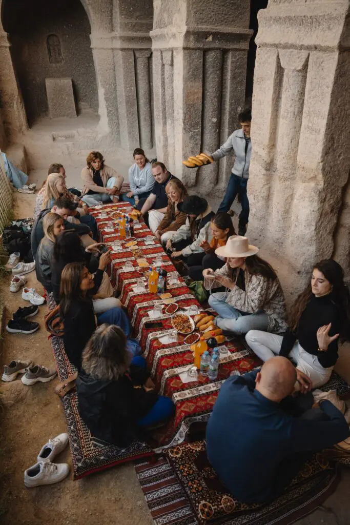 group of people enjoying a traditional meal in a cave restaurant