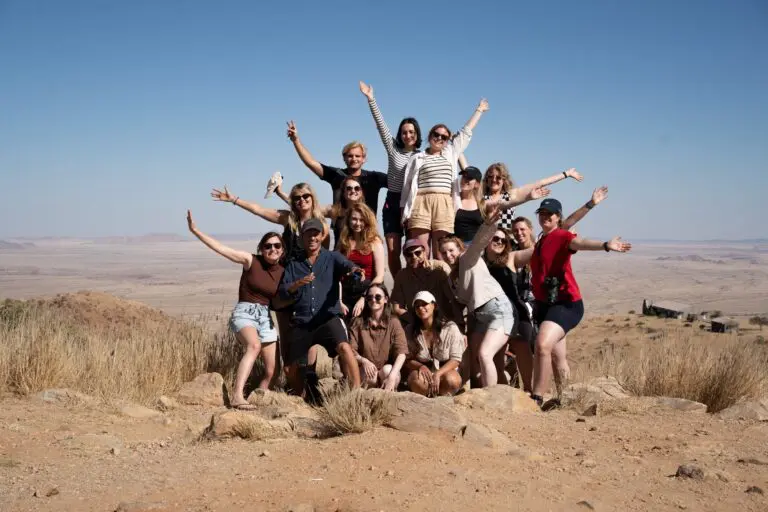 large group of young people posing on a hill in Namibia