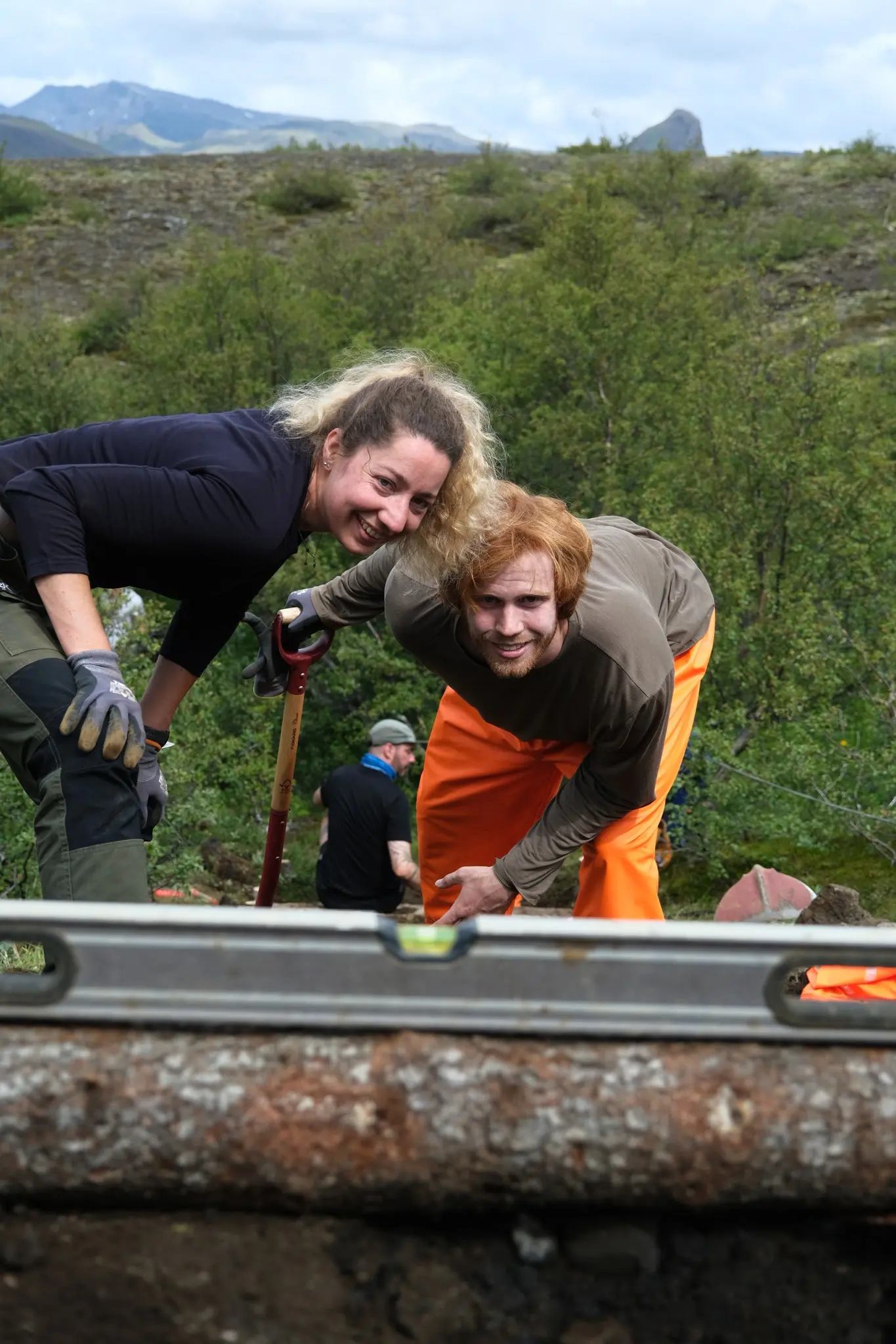 two volunteers smiling while working on a trail in Iceland
