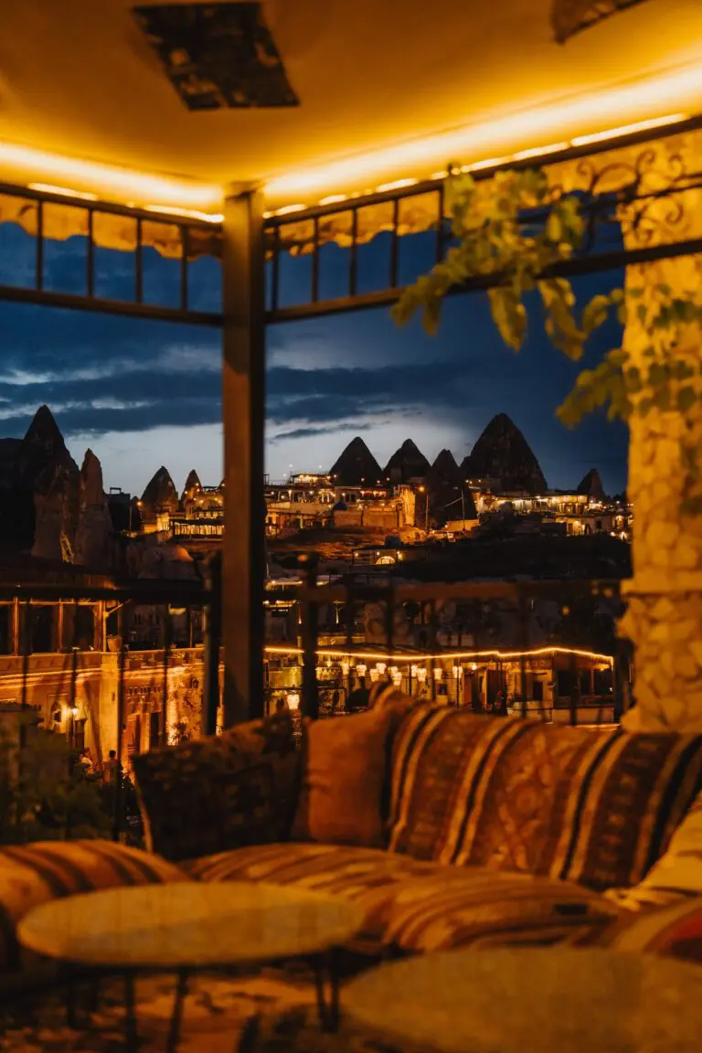 cozy outdoor lounge with view of illuminated Cappadocia fairy chimneys at night