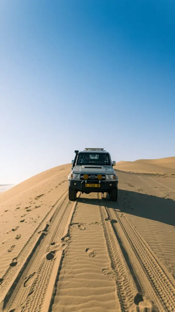 4x4 vehicle driving on sand dunes in Namibia