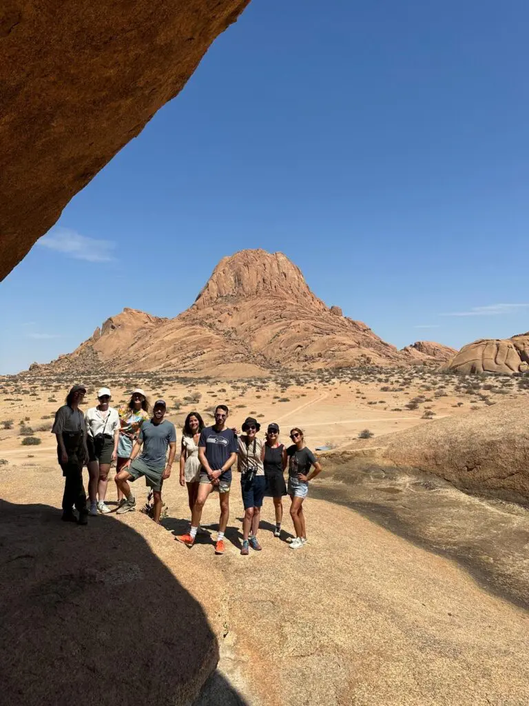 group of friends posing in front of Spitzkoppe mountain, Namibia