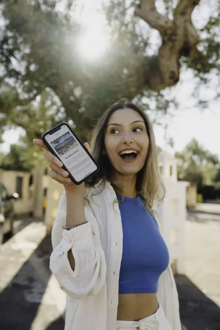 woman holding phone with travel app in Puglia