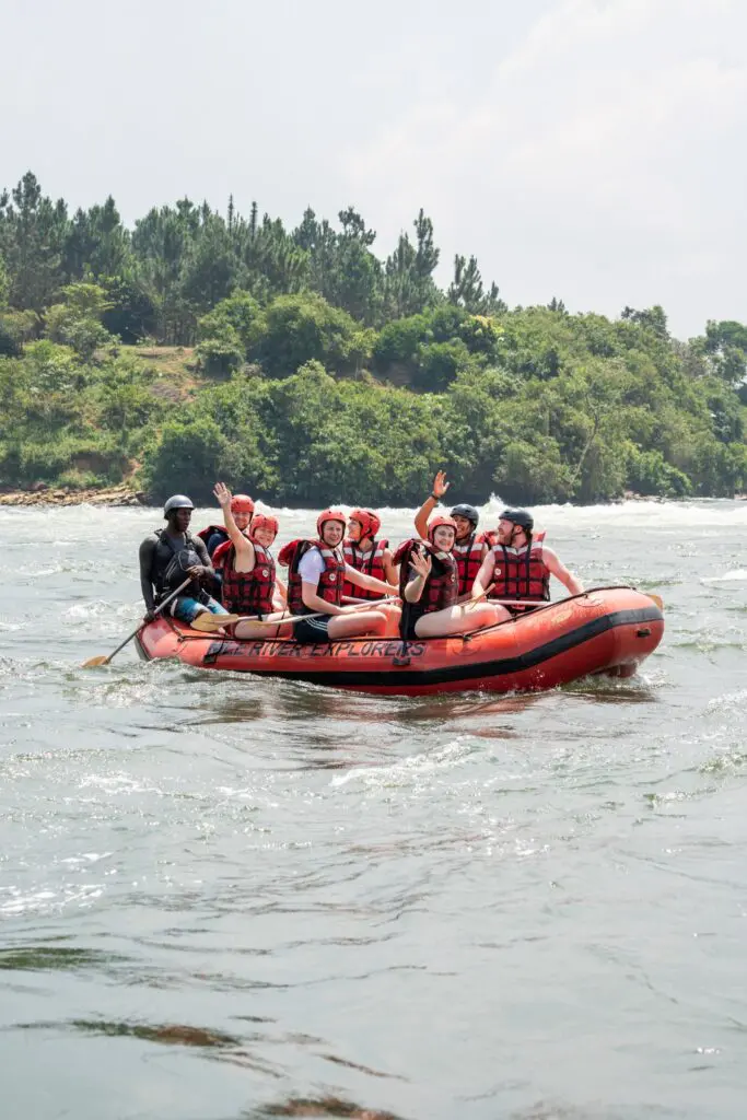 group of people white water rafting on a river in Uganda