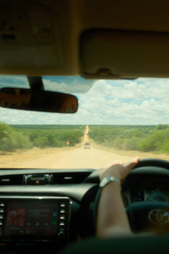 driving on a long dusty road in Namibia