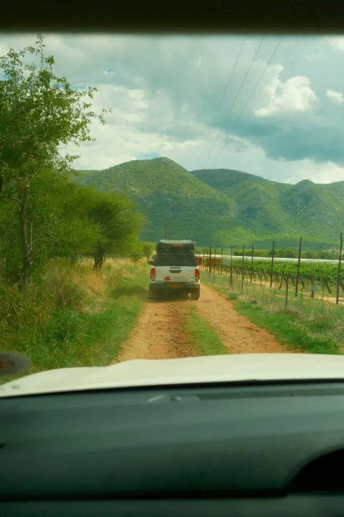 off-road vehicle driving on a dirt track in Namibia