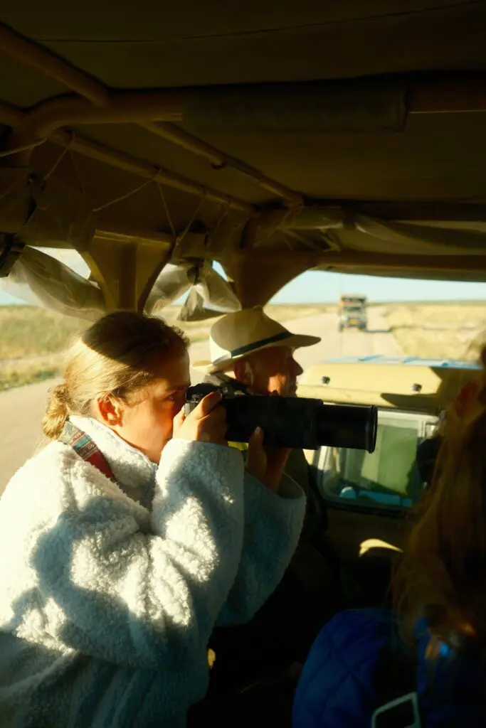 woman on safari taking photos from vehicle in Namibia