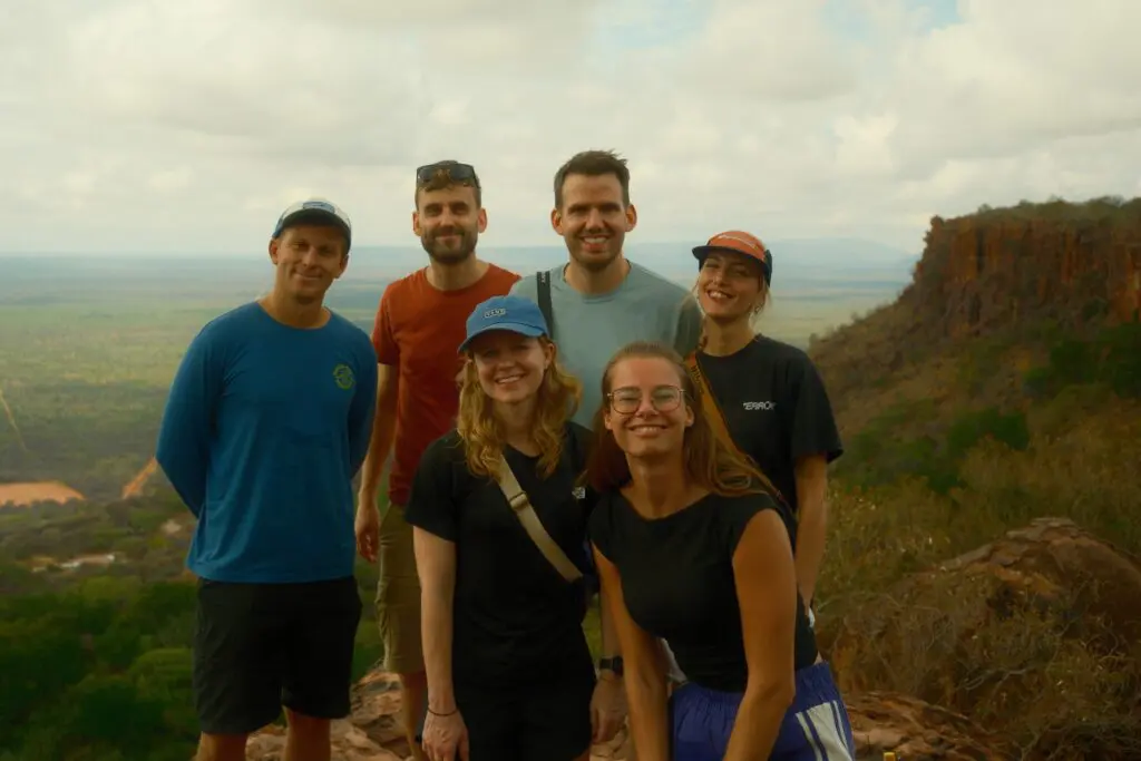 group of friends posing on a mountain in Namibia