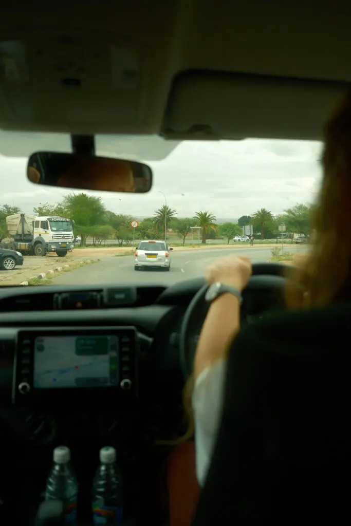 driving through a town in Namibia with palm trees