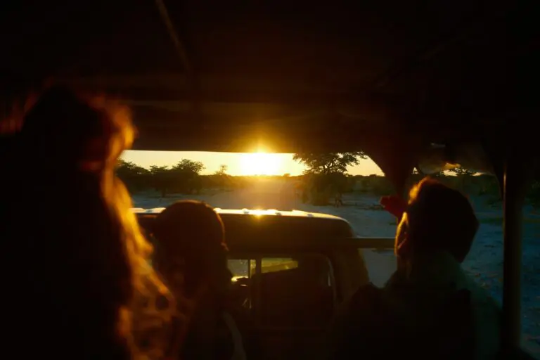 people on safari jeep watching sunset in Namibia