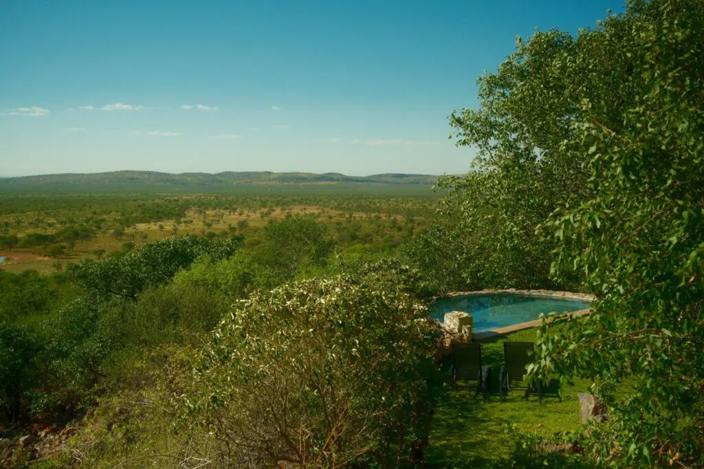 infinity pool overlooking vast Namibian savanna landscape