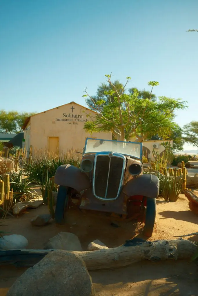 old rusty car in front of Solitaire Immanuel Church in Namibia