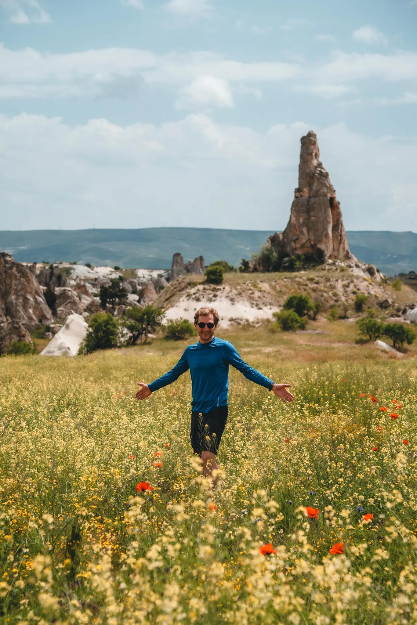 man in blue shirt in field of wildflowers in Cappadocia