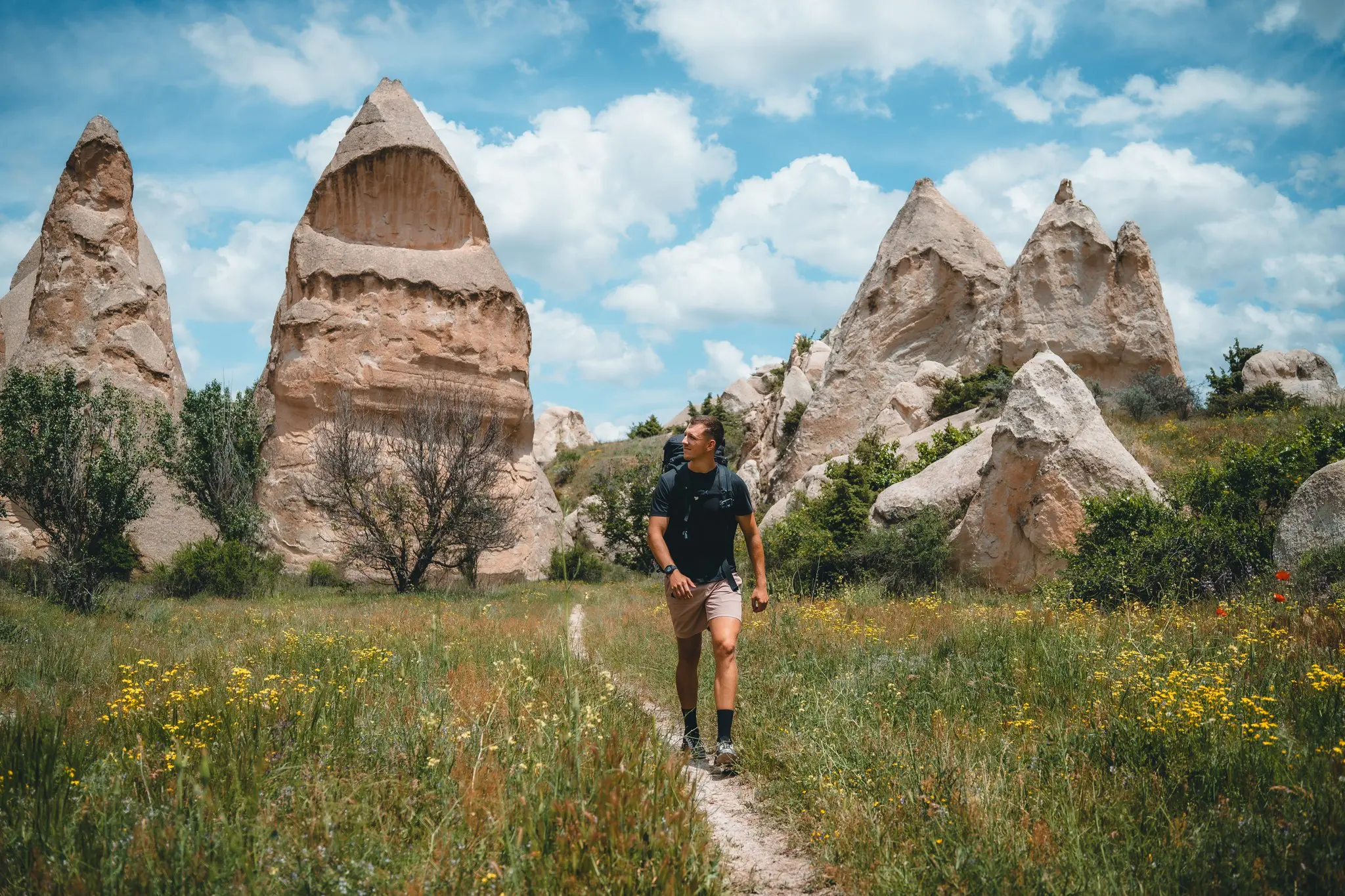 hiker on trail through fairy chimneys in Cappadocia, Turkey