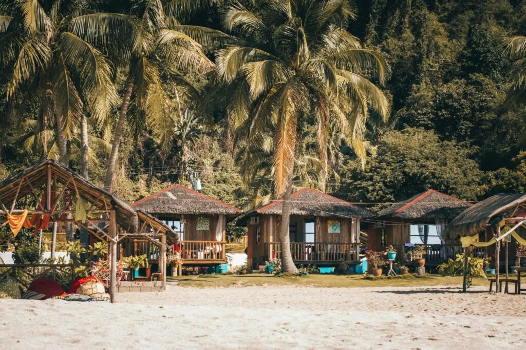 beachfront bungalows under palm trees in the Philippines
